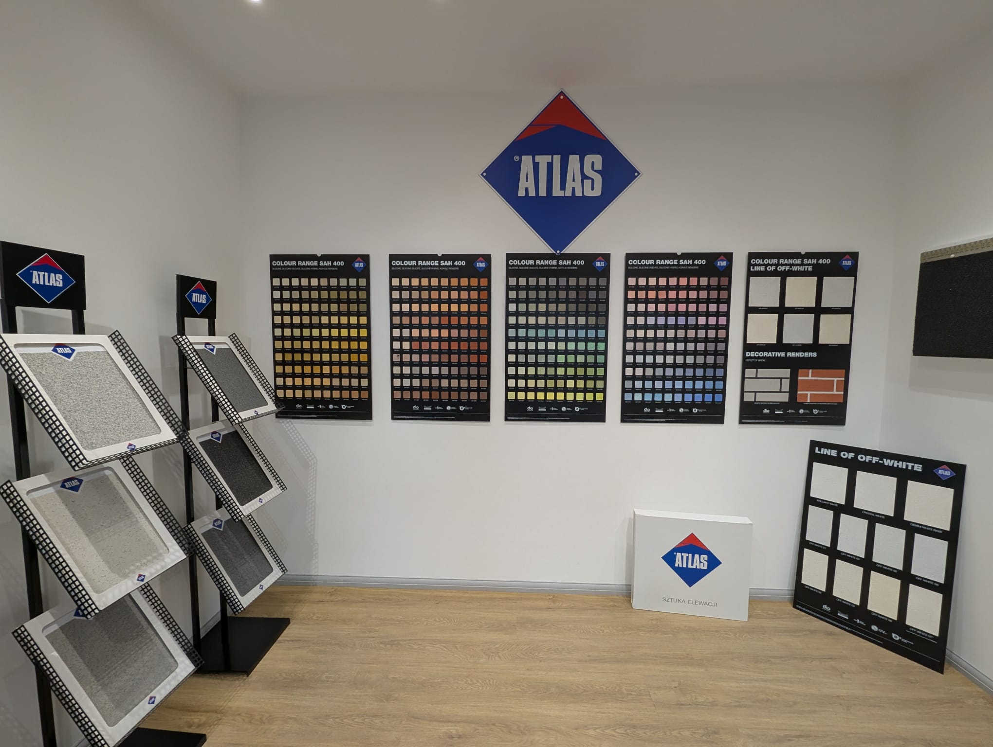 Atlas render colour range display in the showroom, with silicone render colour charts and textured sample boards for external wall insulation finishes